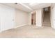 Basement with neutral carpet features stairs to upper level, access to the bathroom, and a white door at 15565 Flowerhill Cir, Parker, CO 80134