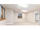 Bright basement features a ceiling fan, window, neutral paint and carpet, with a doorway to another room at 15565 Flowerhill Cir, Parker, CO 80134