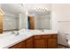 Well-lit bathroom featuring double sinks and vanity, offering a clean and functional design at 15565 Flowerhill Cir, Parker, CO 80134