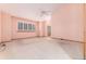 Spacious bedroom with a ceiling fan and light pink walls, offering natural light from large windows at 15565 Flowerhill Cir, Parker, CO 80134
