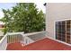 Red painted wood deck with white railing, stairs and sliding glass door to indoors features surrounding trees at 15565 Flowerhill Cir, Parker, CO 80134