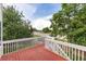 Wood deck with white railing offers great views of the neighborhood and surrounding trees and landscaping at 15565 Flowerhill Cir, Parker, CO 80134