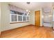 Dining room area features wood floors, a large window with shutters and hanging pendant lights at 15565 Flowerhill Cir, Parker, CO 80134