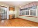 Dining room features a sliding glass door, wood floors, a built-in desk area, and a large window with shutters at 15565 Flowerhill Cir, Parker, CO 80134
