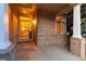 Inviting brick front porch with classic white columns and a glass front door at 15565 Flowerhill Cir, Parker, CO 80134