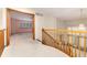 Open hallway features wooden banisters and views into a bright living room with large windows at 15565 Flowerhill Cir, Parker, CO 80134