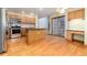 Kitchen area features wood floors, a kitchen island, wood cabinets and stainless steel appliances at 15565 Flowerhill Cir, Parker, CO 80134
