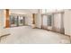 Spacious living room with large windows, natural light, and decorative columns at 15565 Flowerhill Cir, Parker, CO 80134