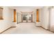 Open living room with natural light, and decorative columns at 15565 Flowerhill Cir, Parker, CO 80134