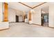 Open living room with natural light, and decorative columns at 15565 Flowerhill Cir, Parker, CO 80134