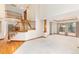 Open living room with staircase featuring natural light, and decorative columns at 15565 Flowerhill Cir, Parker, CO 80134