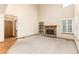 Large living room with a fireplace, high ceilings, and built in shelves at 15565 Flowerhill Cir, Parker, CO 80134