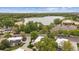 Aerial view showcasing the property's location near a lake and surrounding greenery with city skyline at 1799 S Lee St # B, Lakewood, CO 80232