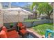 Cozy backyard with a patio set and an umbrella on brick and a grassy area at 1799 S Lee St # B, Lakewood, CO 80232