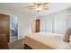 Spacious bedroom with a queen bed, ceiling fan, and closet space for storage at 1799 S Lee St # B, Lakewood, CO 80232
