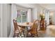 Cozy dining area with natural lighting, a wood table with four chairs, and neutral decor at 1799 S Lee St # B, Lakewood, CO 80232