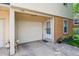 Attached garage with secure entry door, flower bed, and well-maintained exterior at 1799 S Lee St # B, Lakewood, CO 80232
