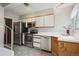 Modern kitchen with stainless steel appliances, white cabinets, tile floors, and plenty of counter space at 1799 S Lee St # B, Lakewood, CO 80232