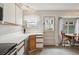 Traditional kitchen features tile flooring, white countertops and cabinetry, and a dining area at 1799 S Lee St # B, Lakewood, CO 80232
