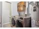 Well-equipped laundry room featuring a modern washer and dryer, with storage cabinets at 1799 S Lee St # B, Lakewood, CO 80232