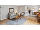 Cozy living room featuring hardwood floors, a comfortable sofa, and an open layout to the kitchen at 1799 S Lee St # B, Lakewood, CO 80232