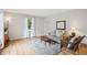 Inviting living room with hardwood floors, a neutral color scheme, and natural light from the window at 1799 S Lee St # B, Lakewood, CO 80232