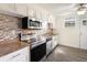 Modern kitchen featuring stainless steel appliances and a tile backsplash at 9250 E Girard Ave # 8, Denver, CO 80231