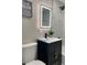 Stylish bathroom with a modern vanity, lighted mirror, and elegant tile work at 1263 N Willow St, Denver, CO 80220