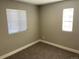 Empty bedroom featuring neutral-toned walls, carpeted floors, and natural light from two windows at 1263 N Willow St, Denver, CO 80220