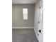 Cozy bedroom featuring soft gray carpet, white trim, and natural light from a window at 1263 N Willow St, Denver, CO 80220