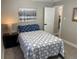 Bedroom with a blue and white patterned bedspread, artwork, and a view into hallway at 1263 N Willow St, Denver, CO 80220