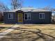 Well-kept home with gray exterior and a striking yellow door at 1263 N Willow St, Denver, CO 80220