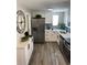 Modern kitchen with white cabinets, stainless steel appliances, and a stylish backsplash at 1263 N Willow St, Denver, CO 80220