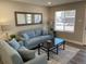 Comfortable living room with matching blue furniture, neutral walls, and natural light at 1263 N Willow St, Denver, CO 80220