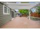 This wooden deck is covered by a pergola, creating a shaded spot to enjoy views of the yard and garden at 3389 Willowrun Dr, Castle Rock, CO 80109