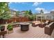 Inviting backyard patio with a cozy fire pit, modern seating, and a pergola with string lights for outdoor relaxation at 3389 Willowrun Dr, Castle Rock, CO 80109