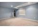 Finished basement space with a neutral carpet, boxing equipment, and natural light from a window at 3389 Willowrun Dr, Castle Rock, CO 80109