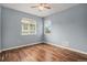 Bedroom featuring hardwood floors, two windows, and neutral paint at 3389 Willowrun Dr, Castle Rock, CO 80109
