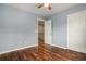 Bedroom with hardwood floors, blue walls, and a closet with a view of the staircase landing at 3389 Willowrun Dr, Castle Rock, CO 80109