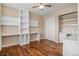 Versatile bedroom space featuring built-in shelving, hardwood floors, and closet at 3389 Willowrun Dr, Castle Rock, CO 80109