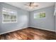 Bright bedroom with hardwood floors and windows providing views of the surrounding area at 3389 Willowrun Dr, Castle Rock, CO 80109