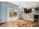 Breakfast nook with hardwood floors, stone bar, backyard view through sliding glass doors at 3389 Willowrun Dr, Castle Rock, CO 80109