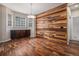 Dining room featuring hardwood floors, decorative wood accent wall, and bright windows at 3389 Willowrun Dr, Castle Rock, CO 80109