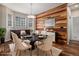 Dining room featuring stylish light fixture, wood accent wall, and decorative rug at 3389 Willowrun Dr, Castle Rock, CO 80109