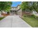 Charming two-story home boasts a manicured lawn, mature trees, and a welcoming front porch at 3389 Willowrun Dr, Castle Rock, CO 80109