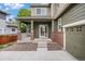 Charming front porch with brick accents leading to the front door and garage entrance at 3389 Willowrun Dr, Castle Rock, CO 80109