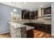 Well-equipped kitchen featuring granite countertops, dark cabinets, and stainless steel appliances at 3389 Willowrun Dr, Castle Rock, CO 80109