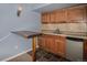 A kitchenette with wood cabinets, tiled backsplash, wet bar, and a mini-fridge at 3389 Willowrun Dr, Castle Rock, CO 80109