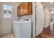 Laundry room with washer, dryer, and storage cabinets at 3389 Willowrun Dr, Castle Rock, CO 80109