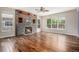 Spacious living room with hardwood floors, a stone fireplace, and ample natural light at 3389 Willowrun Dr, Castle Rock, CO 80109